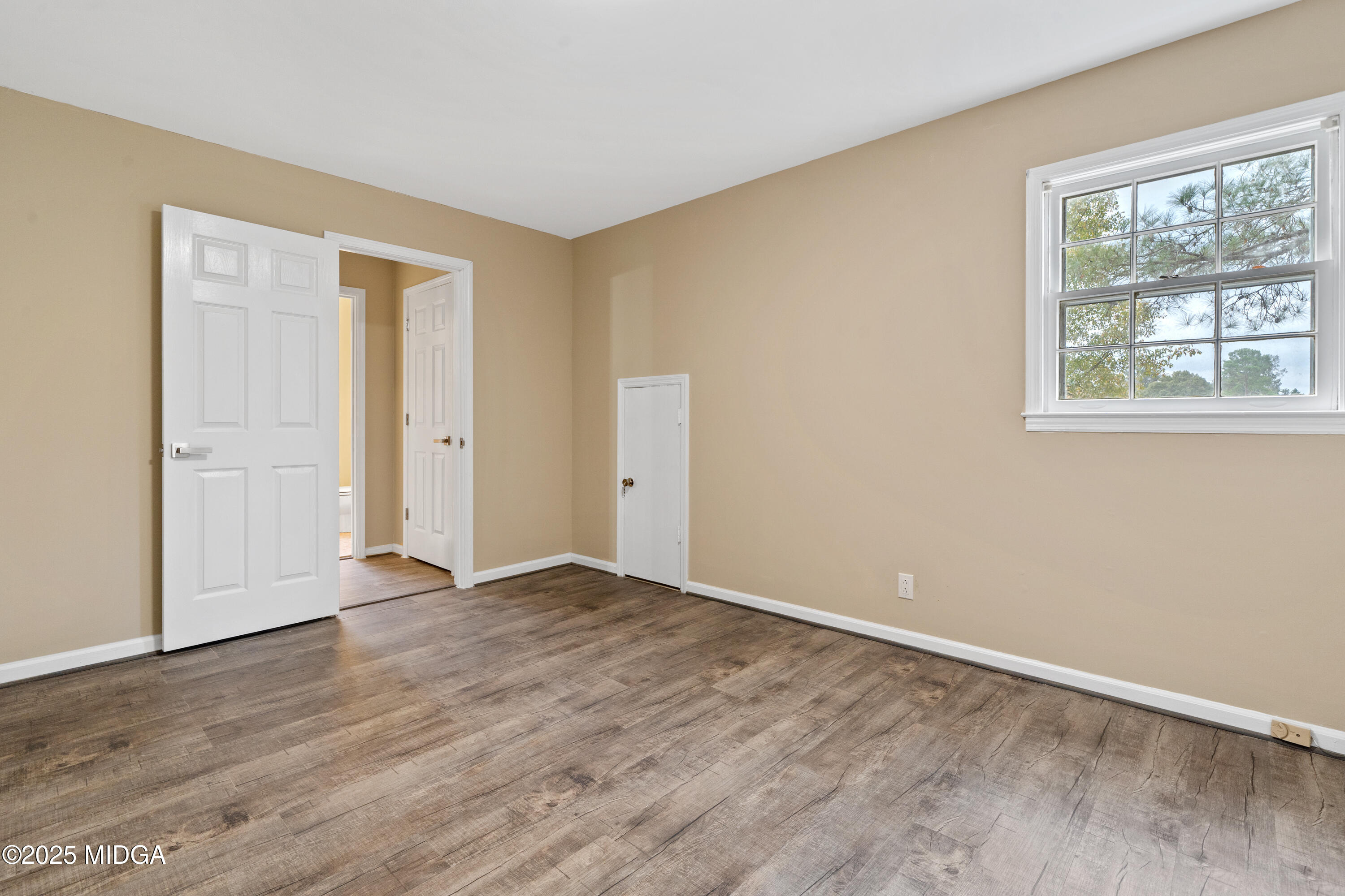 1303 Forest Hill Road Macon, GA 31210 - Photo 32 of 54 a view of an empty room with wooden floor and a window