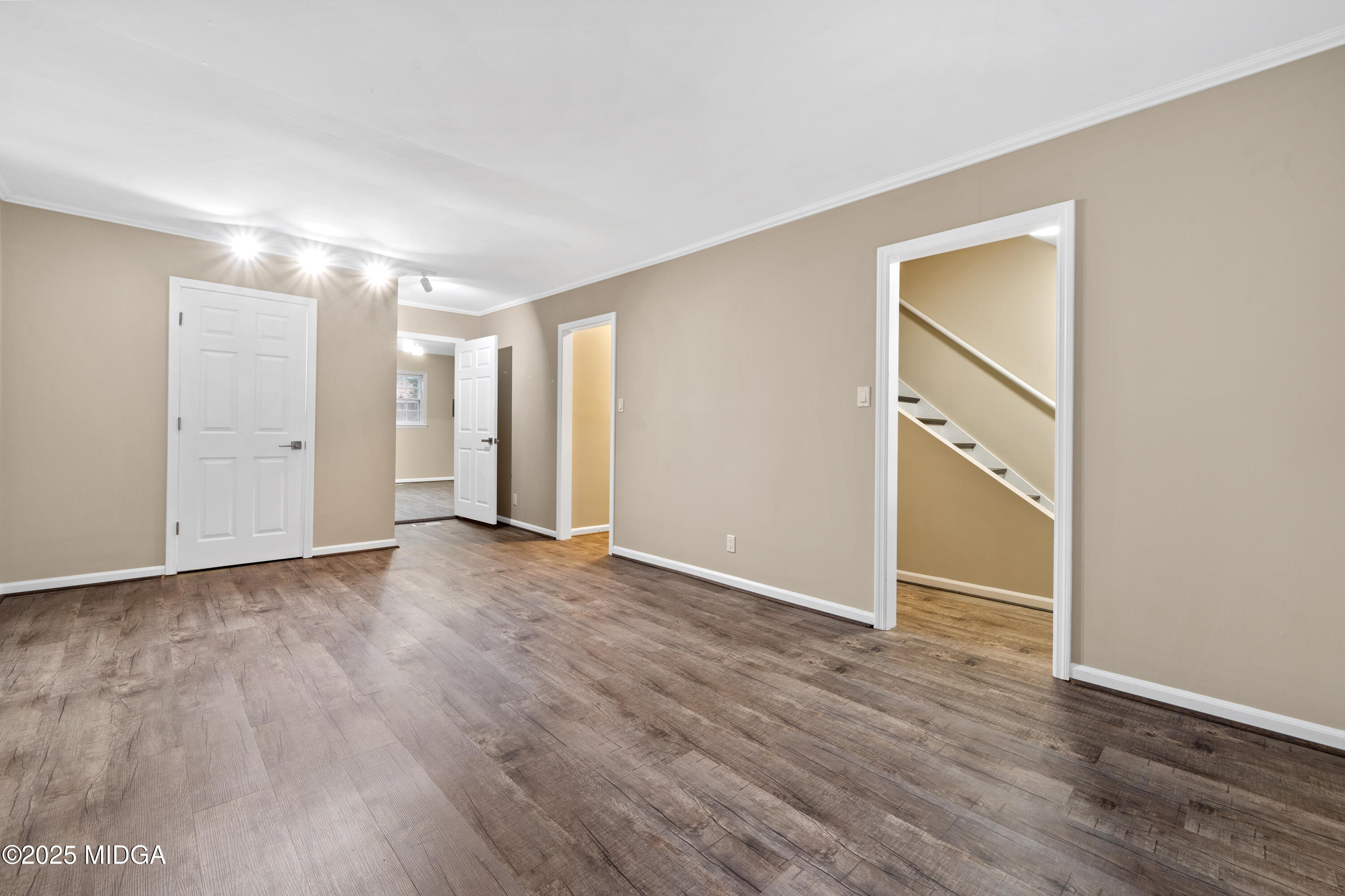 1303 Forest Hill Road Macon, GA 31210 - Photo 6 of 54 an empty room with wooden floor & closet area