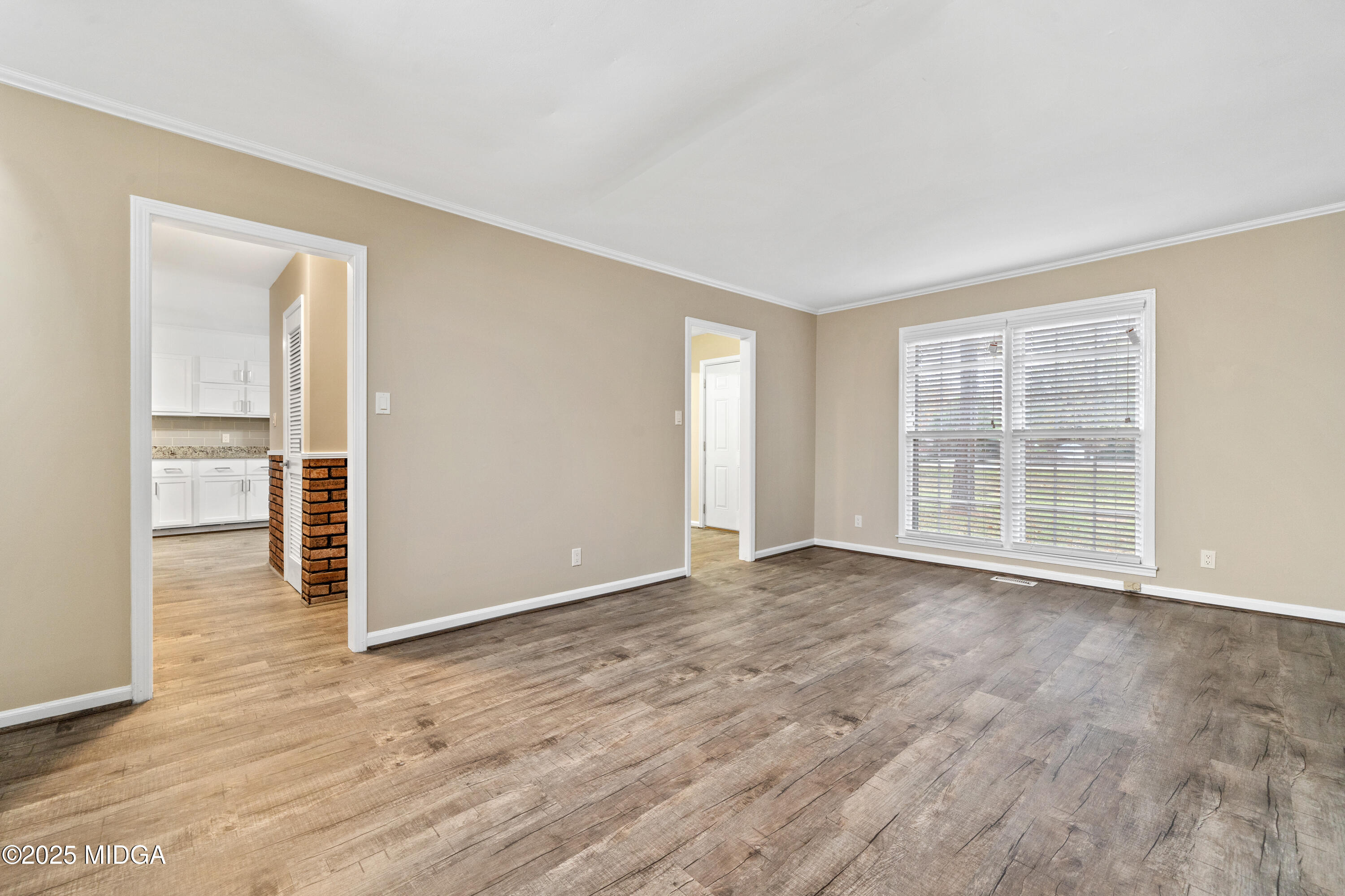 1303 Forest Hill Road Macon, GA 31210 - Photo 7 of 54 an empty room with wooden floor and windows