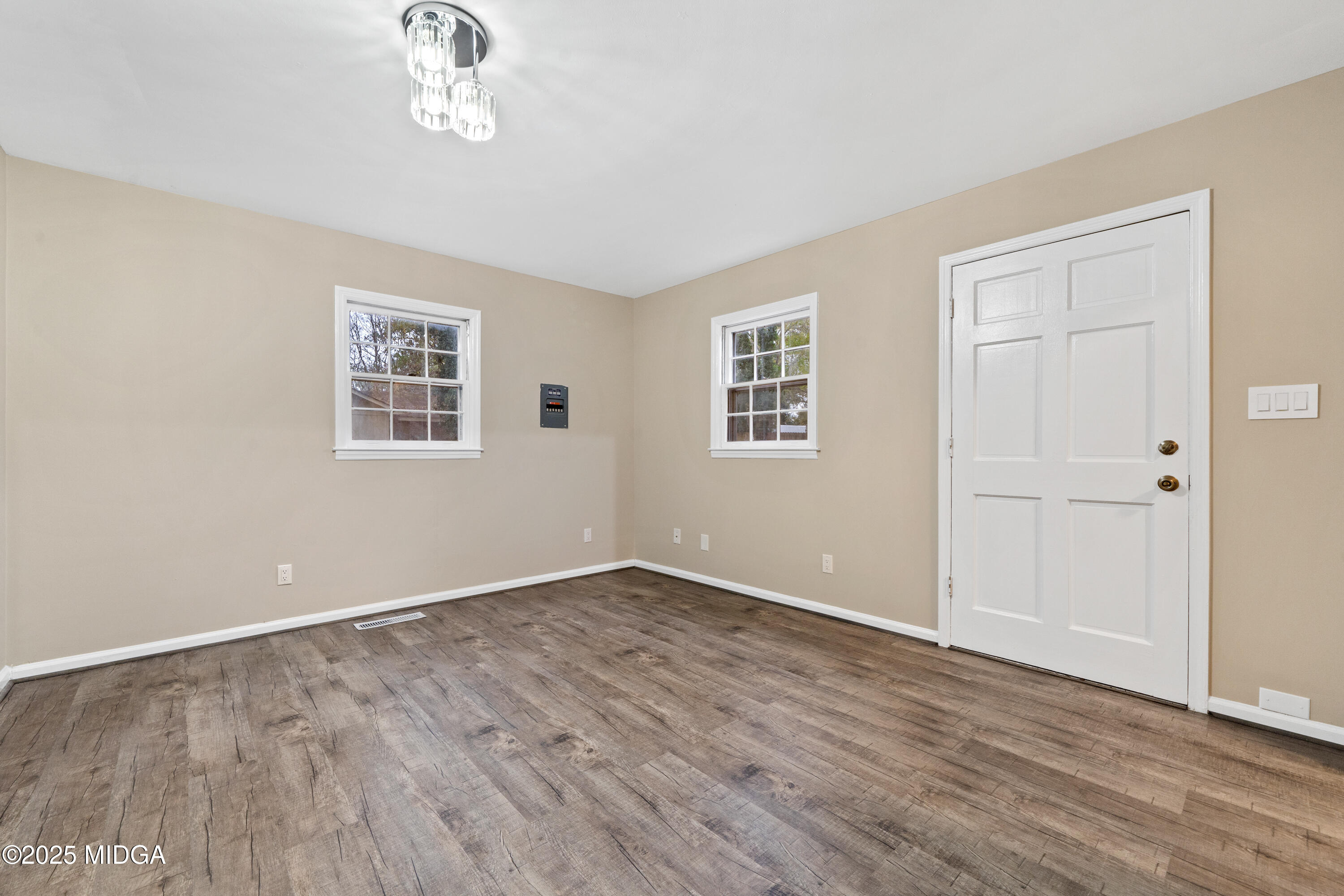 1303 Forest Hill Road Macon, GA 31210 - Photo 9 of 54 a view of an empty room with wooden floor and a window