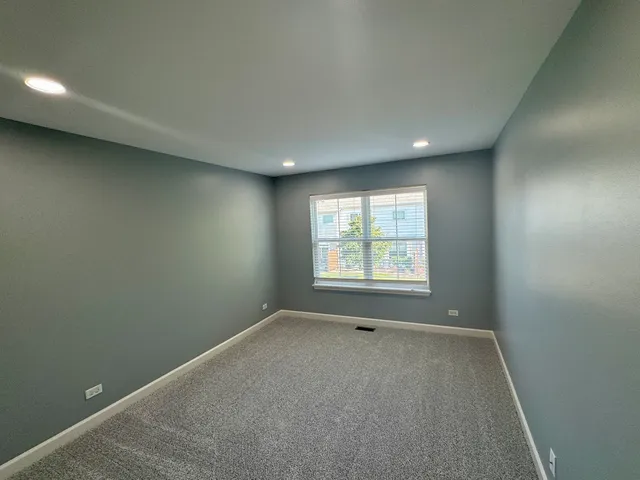 an empty room with closet and mirror