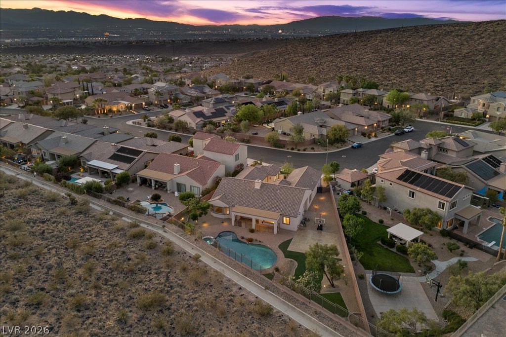 2125 De Rouge Avenue Henderson, NV 89044 - Photo 89 of 96 An aerial perspective reveals a serene residential neighborhood nestled against a majestic mountain backdrop.