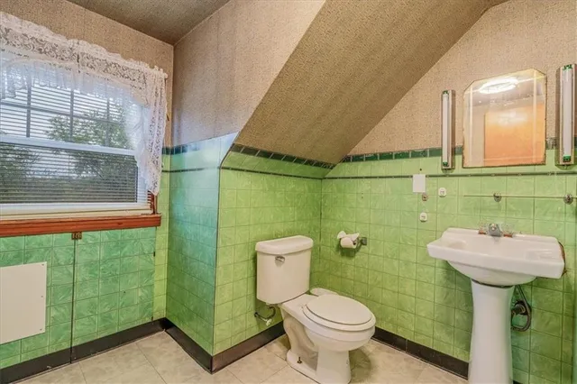a bedroom with two beds and a book shelf