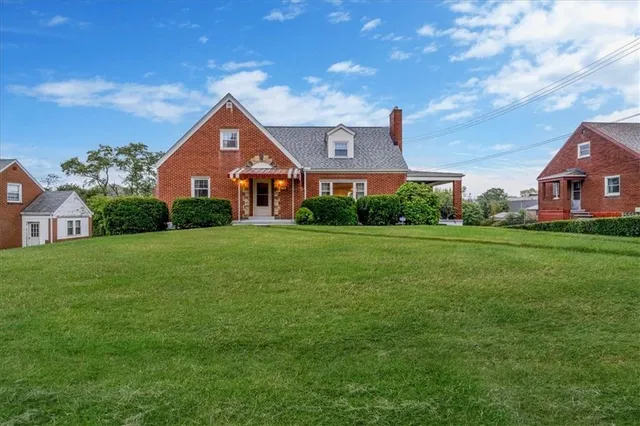 a front view of a house with yard