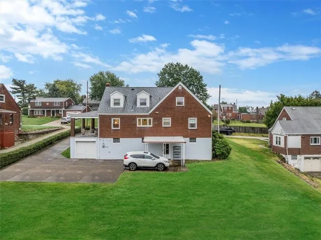 an aerial view of a house with a big yard