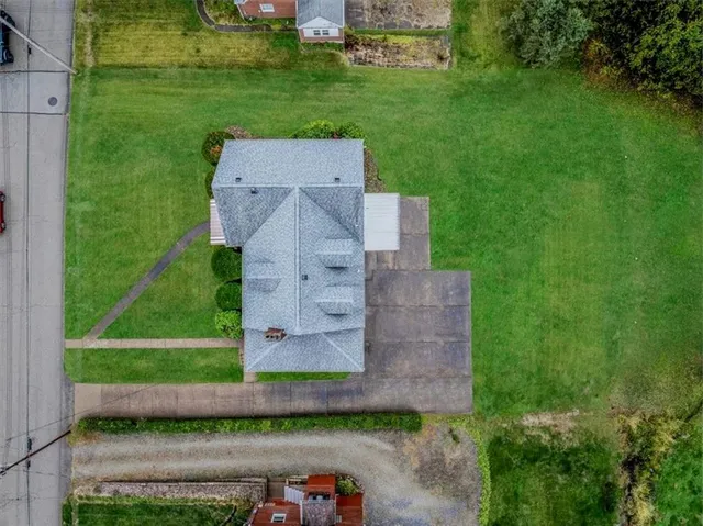 an aerial view of a house with a yard