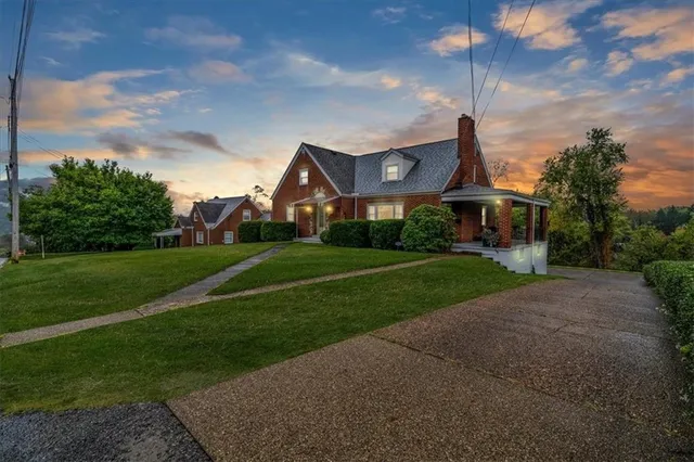 a front view of house with yard and green space