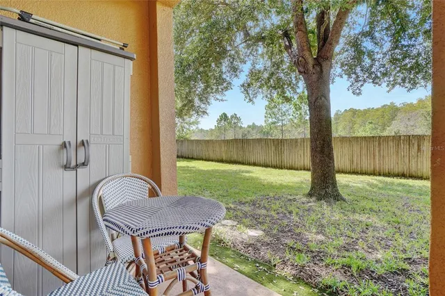 a view of a porch with furniture and a yard