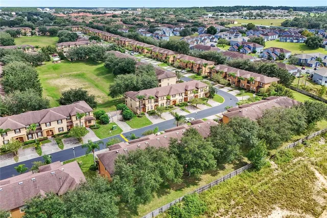 an aerial view of residential houses with outdoor space