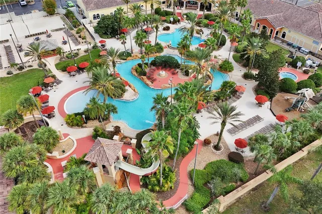 an aerial view of a house with yard swimming pool and outdoor seating