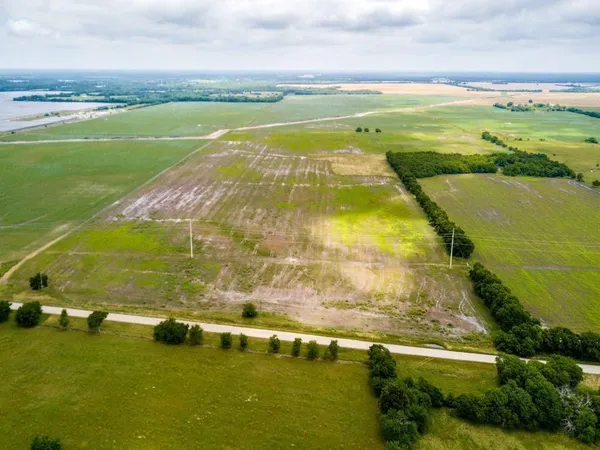 a view of an ocean beach and residential houses