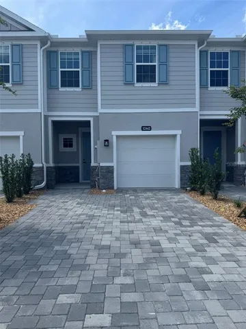a front view of a house with a yard and a garage