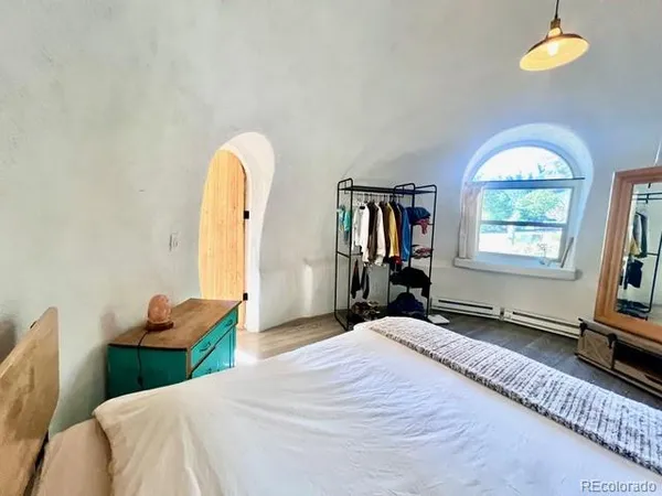 a bedroom with a bed and a window