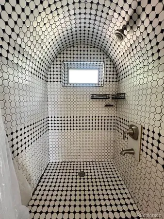 a bathroom with a black and white checkered floor