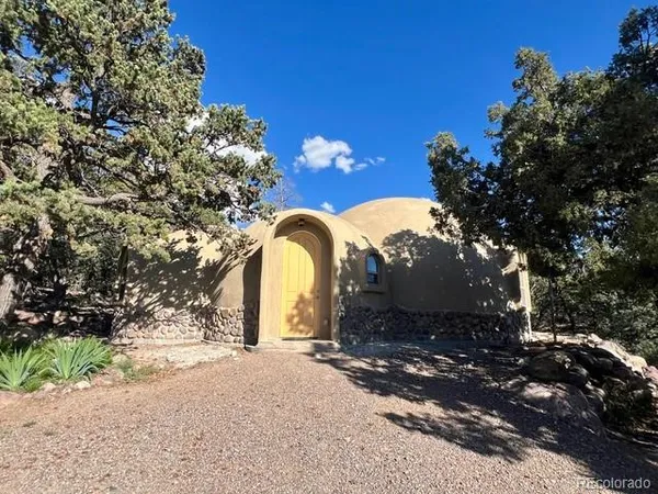 a backyard of a house with table and chairs