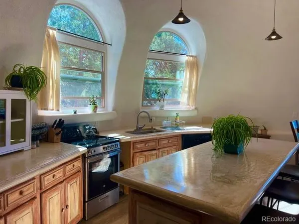 a kitchen with a table chairs and window