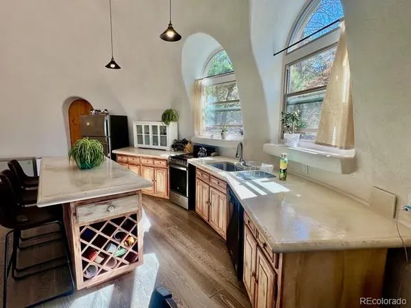 a kitchen with stainless steel appliances granite countertop a sink stove and cabinets