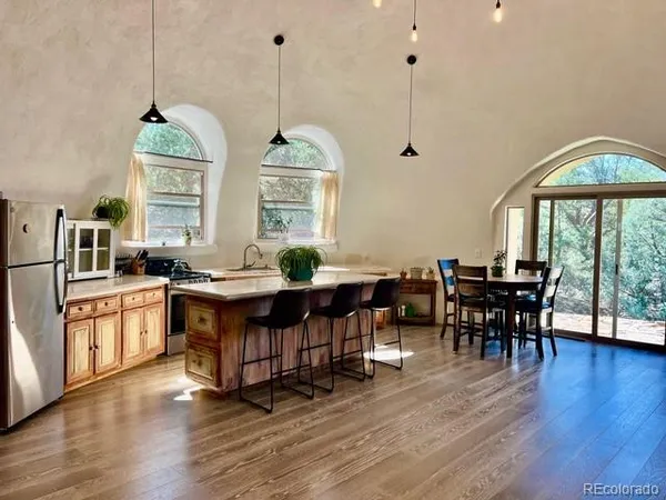 a dining hall with furniture window and wooden floor