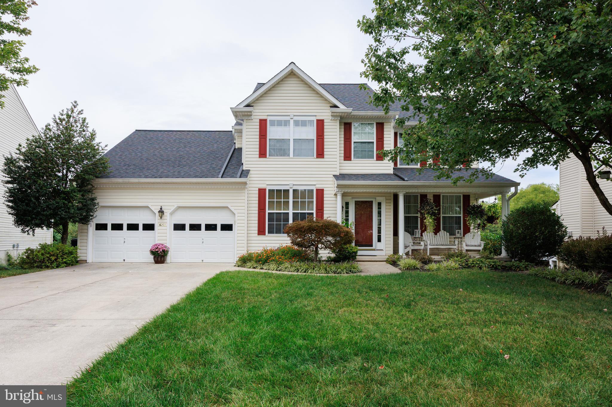 a view of house with yard and porch