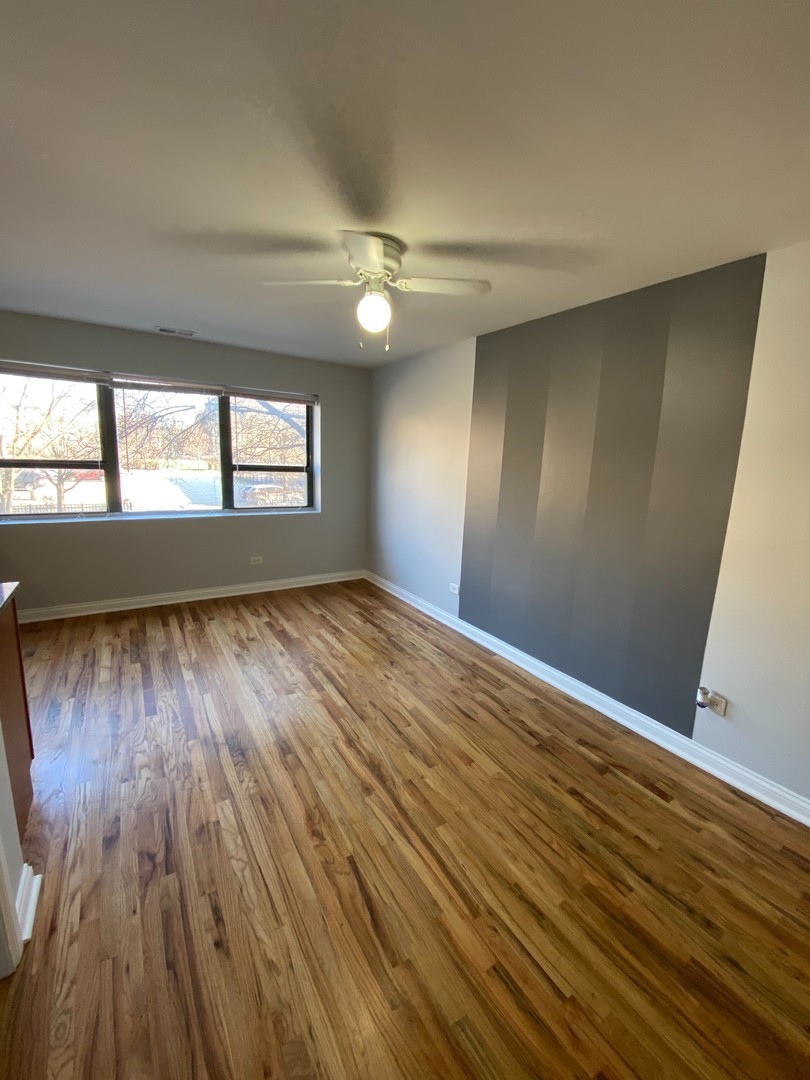 7616 North Marshfield Avenue, Unit 509 Chicago, IL 60626 - Photo 3 of 13 wooden floor in an empty room with a window