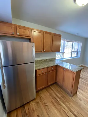 a kitchen with stainless steel appliances granite countertop a refrigerator sink and cabinets