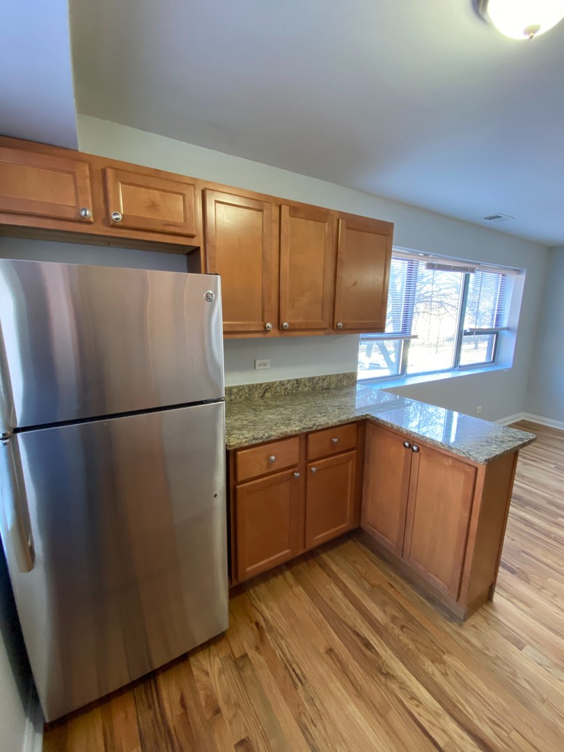7616 North Marshfield Avenue, Unit 509 Chicago, IL 60626 - Photo 5 of 13 a kitchen with stainless steel appliances granite countertop a refrigerator sink and cabinets