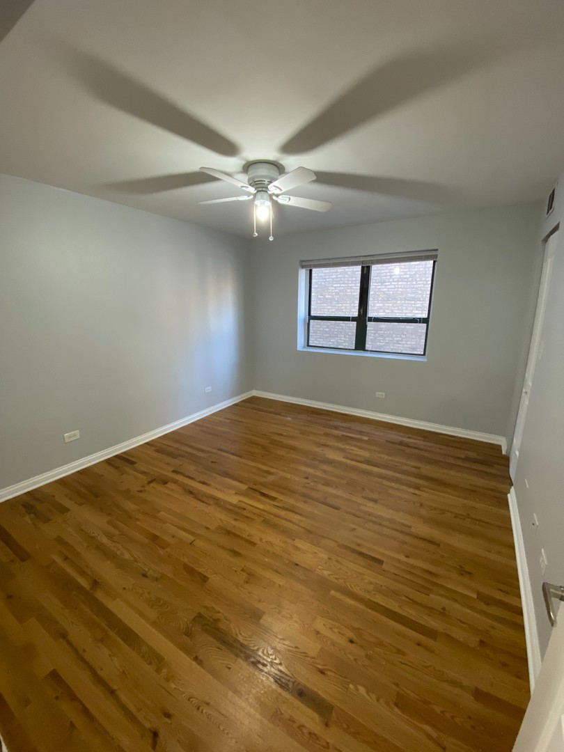 7616 North Marshfield Avenue, Unit 509 Chicago, IL 60626 - Photo 10 of 13 wooden floor in an empty room