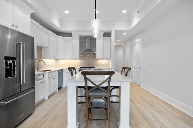 a kitchen with a sink stove top oven and cabinets