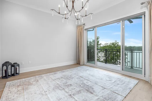 a view of a room with a large bed and large windows