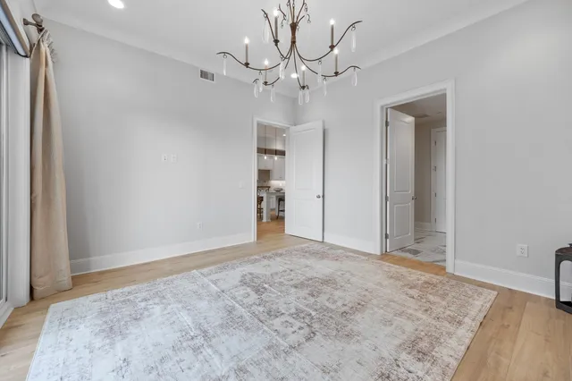 a bedroom with a bed and a chandelier