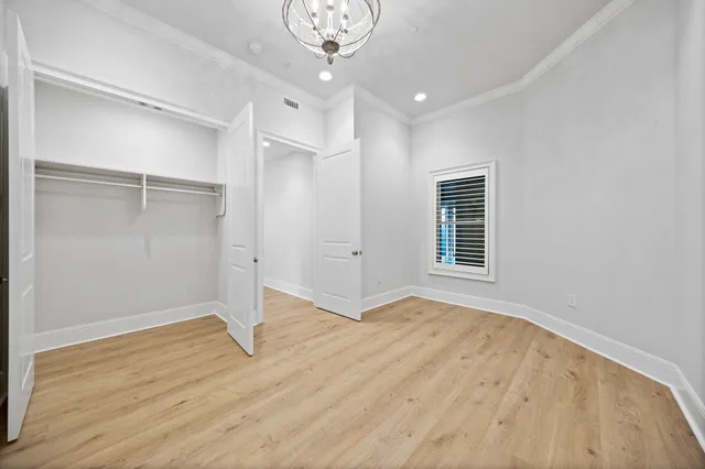 a view of a room with wooden floor and a ceiling fan
