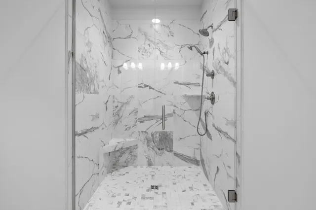 a white toilet sitting next to a shower