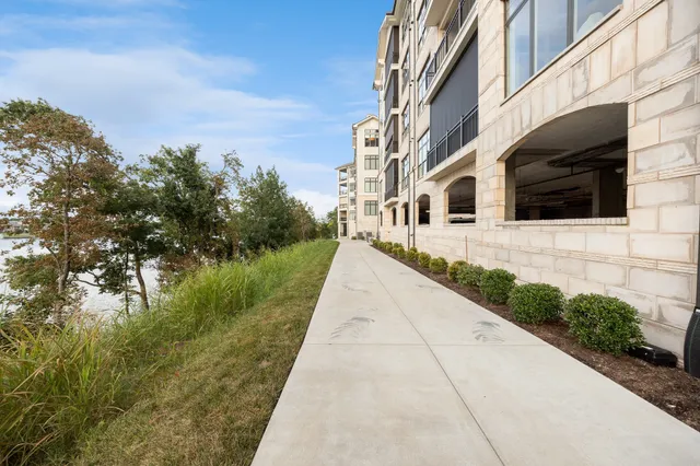 an aerial view of residential houses with outdoor space and river