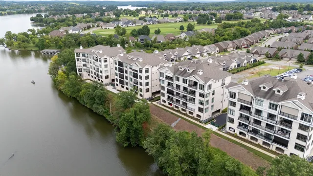 an aerial view of residential building and lake