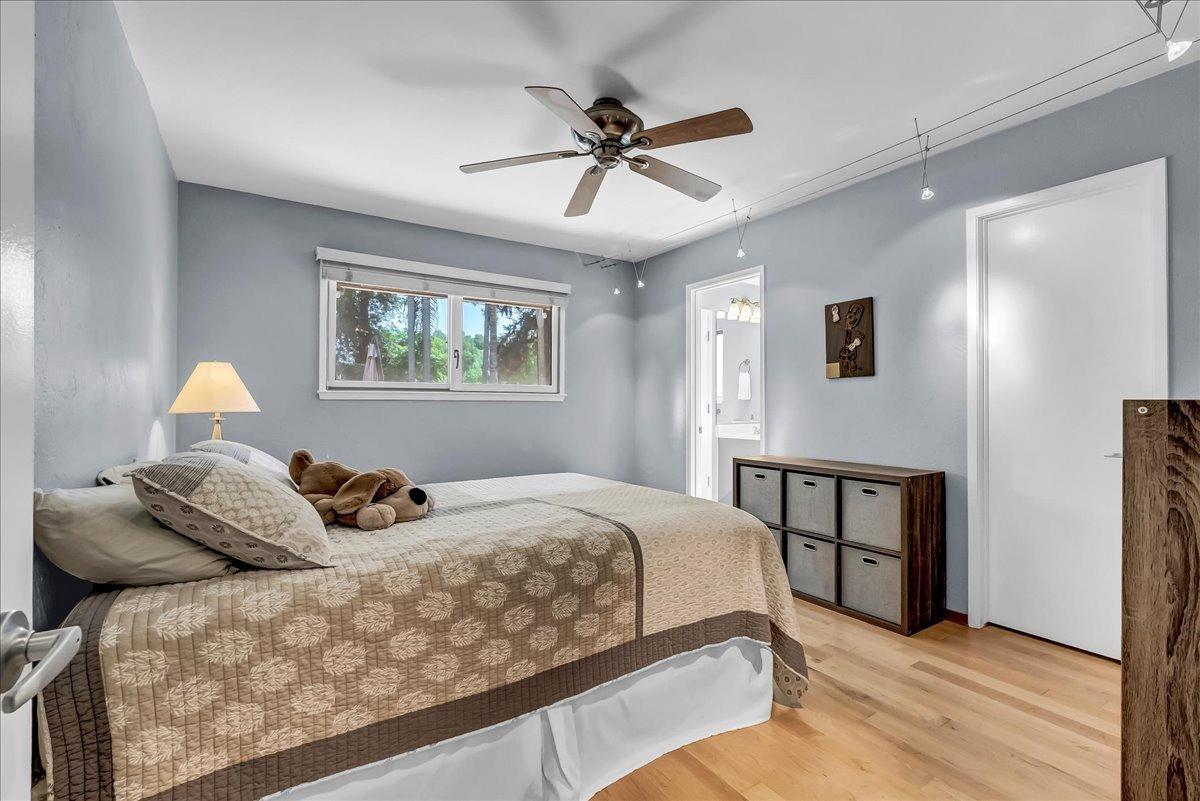 30960 Tower Road Visalia, CA 93292 - Photo 23 of 76 a bedroom with a bed and a chandelier