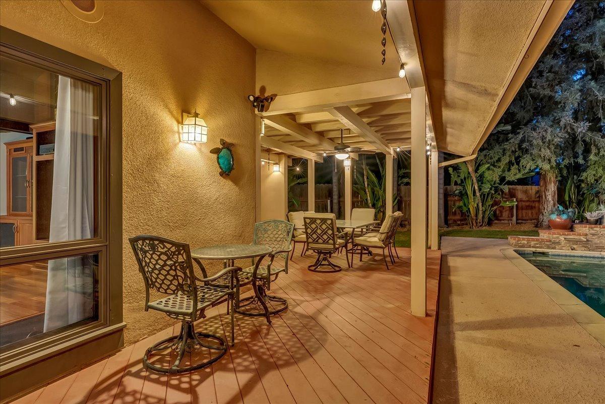 30960 Tower Road Visalia, CA 93292 - Photo 25 of 76 a view of a patio with table and chairs with wooden floor and fence