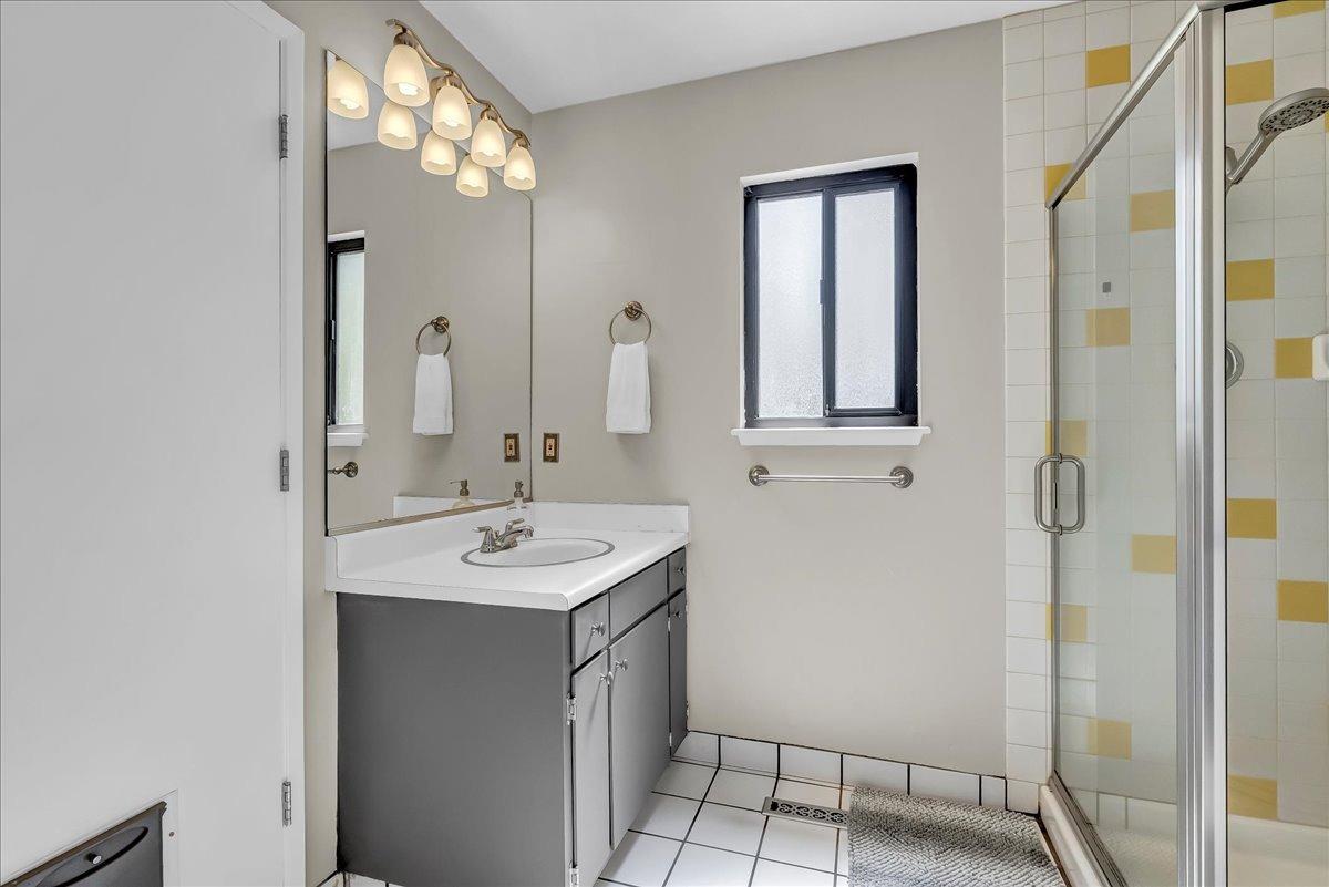 30960 Tower Road Visalia, CA 93292 - Photo 56 of 76 a bathroom with a sink a mirror and shower
