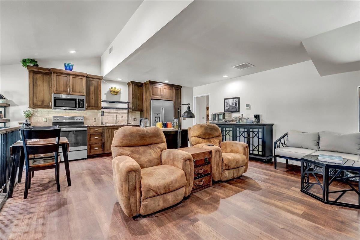 30960 Tower Road Visalia, CA 93292 - Photo 68 of 76 a living room with furniture a flat screen tv and kitchen view