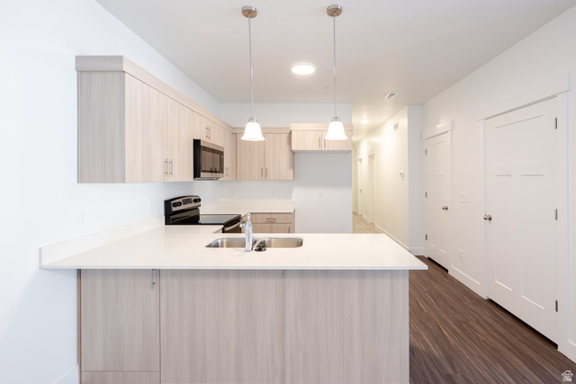 4662 Poplar Way, Unit Q303 Mapleton, UT 84664 - Photo 7 of 18 Kitchen featuring light wood finish cabinets, decorative light fixtures, a peninsula, stainless steel appliances, and dark wood-style floors