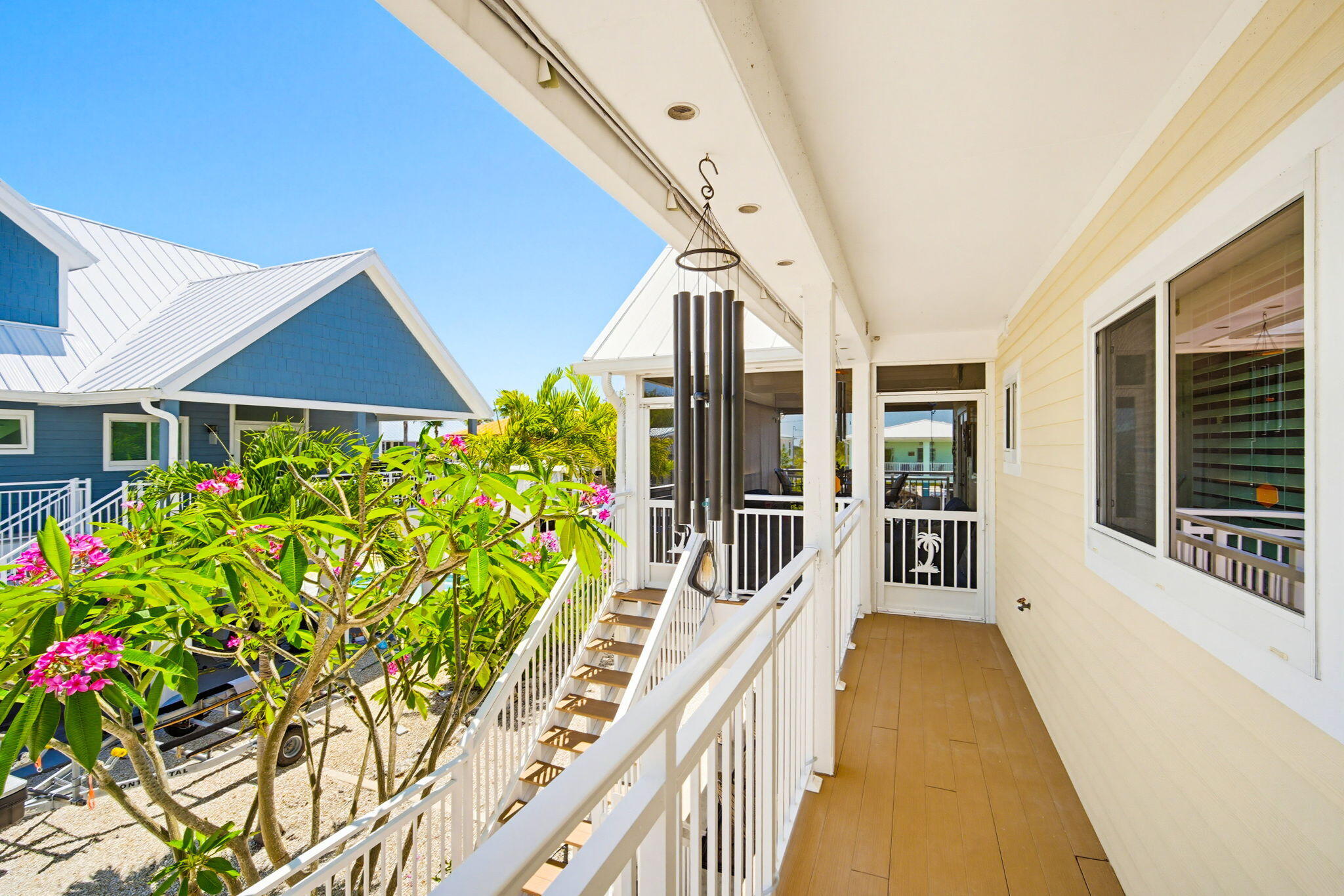 612 Blackbeard Road Summerland Key, FL 33042 - Photo 68 of 68 a front view of a house with large windows and flower plants