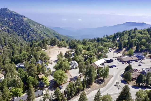 an aerial view of a houses with a street and trees