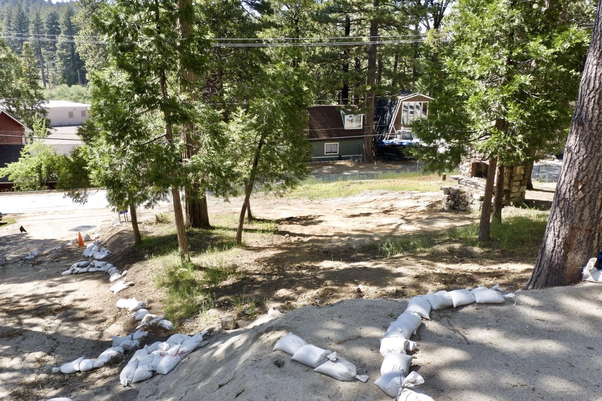 32065 Hunsaker Way, Unit 12 Running Springs, CA 92382 - Photo 5 of 39 a backyard of a house with table and chairs
