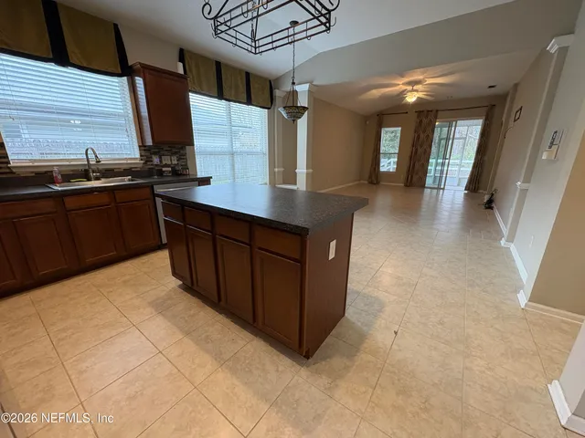 a kitchen with stainless steel appliances a sink stove and cabinets