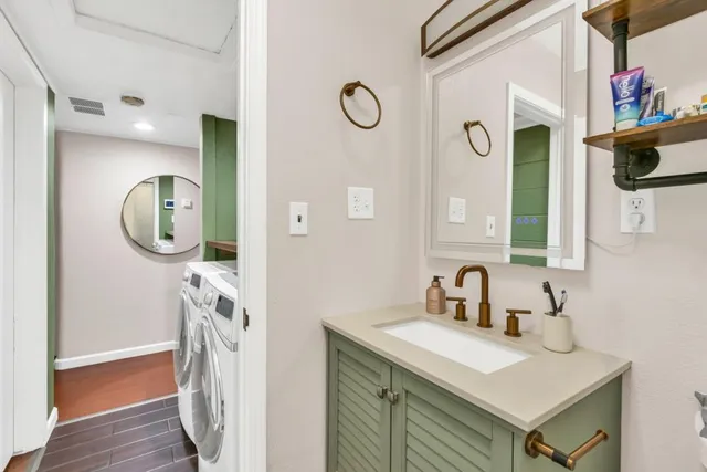a bathroom with a sink a mirror and vanity