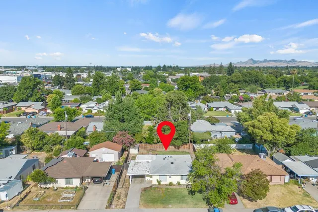 an aerial view of residential houses and lake