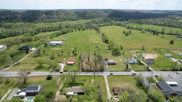 an aerial view of residential houses with outdoor space and river