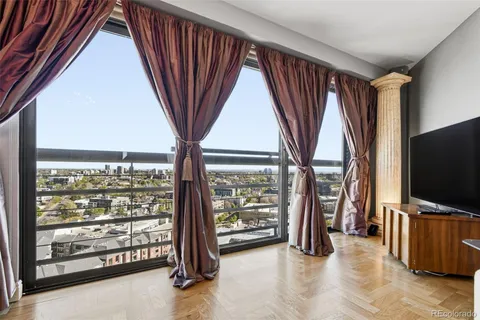 a living room with furniture and a floor to ceiling window