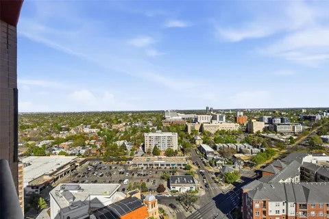a living room with furniture a dining table and a chandelier