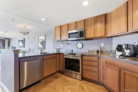 a kitchen with cabinets stainless steel appliances and a sink