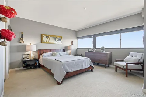 a bedroom with a bed and a couch